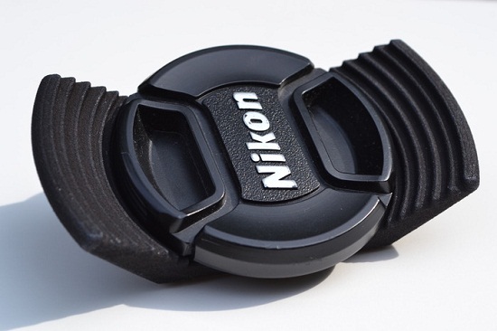Stow-Away Lens Cap Holder keeps track of your cap